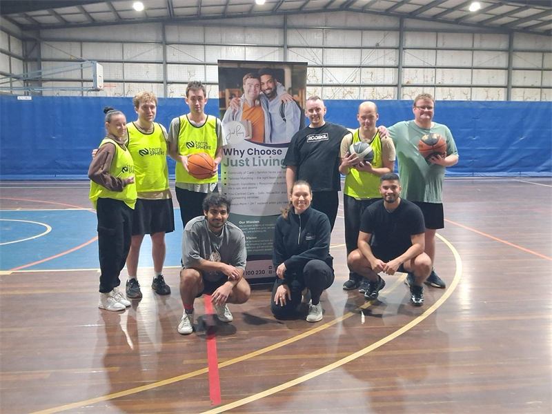Players and volunteers smiling together on the court