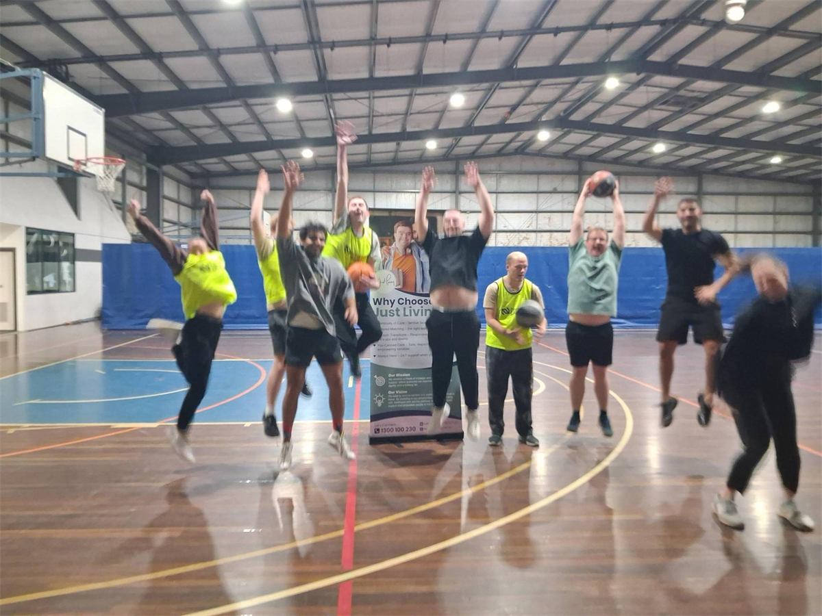 Inclusive Basketball players jumping in the air with their arms raised